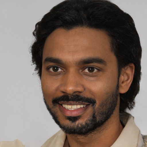 Joyful black young-adult male with short  black hair and brown eyes