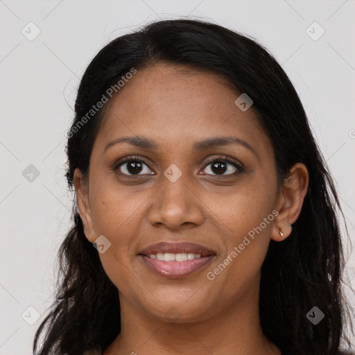 Joyful black young-adult female with long  brown hair and brown eyes