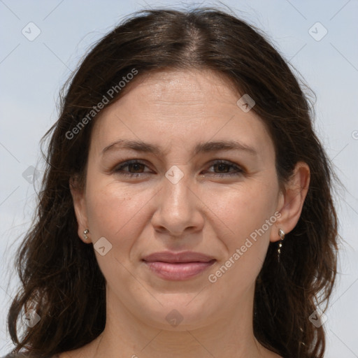 Joyful white adult female with long  brown hair and brown eyes