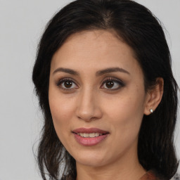 Joyful white young-adult female with medium  brown hair and brown eyes