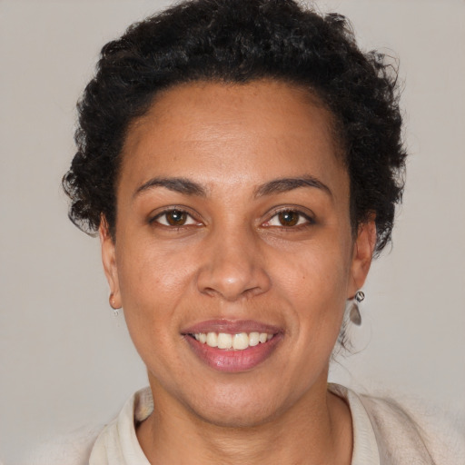 Joyful black young-adult female with short  brown hair and brown eyes