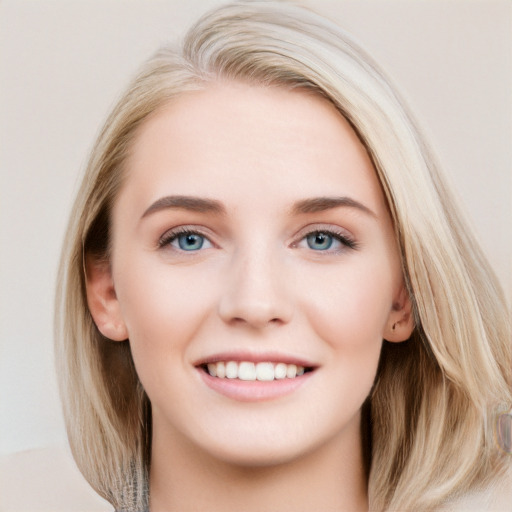 Joyful white young-adult female with long  brown hair and blue eyes