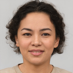 Joyful asian young-adult female with medium  brown hair and brown eyes