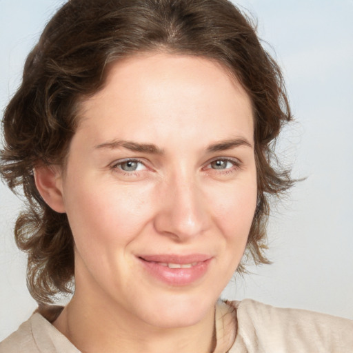 Joyful white young-adult female with medium  brown hair and green eyes