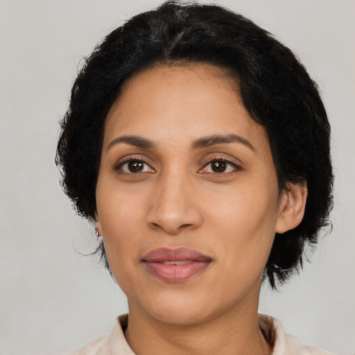 Joyful latino adult female with medium  black hair and brown eyes