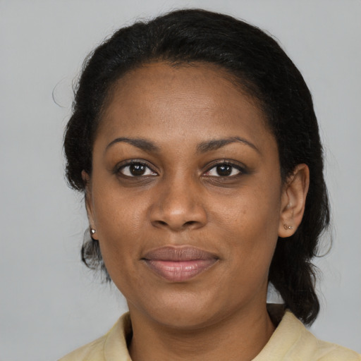 Joyful black adult female with medium  brown hair and brown eyes