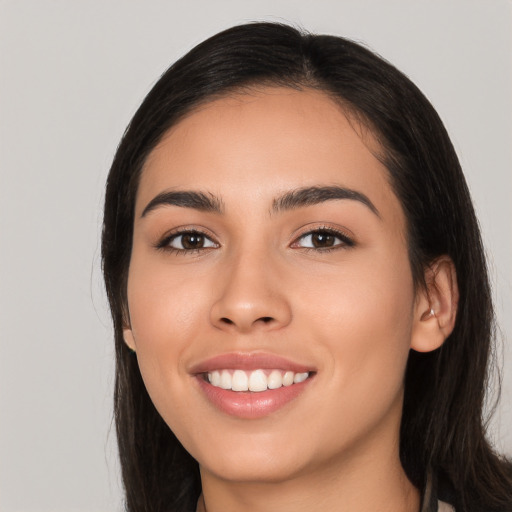 Joyful white young-adult female with long  black hair and brown eyes