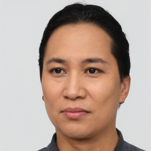 Joyful latino adult female with short  black hair and brown eyes
