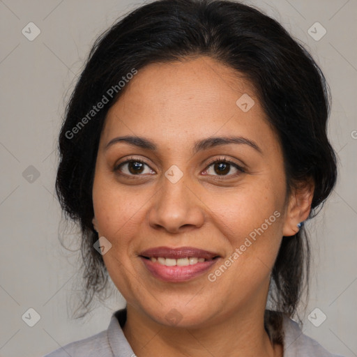 Joyful latino adult female with medium  brown hair and brown eyes