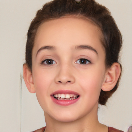 Joyful white child female with short  brown hair and brown eyes