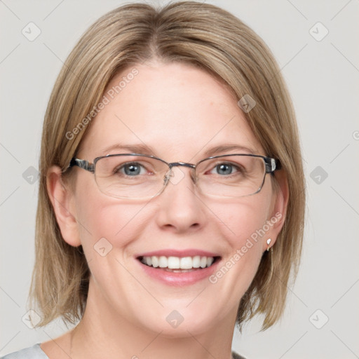 Joyful white adult female with medium  brown hair and blue eyes