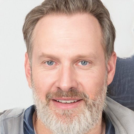 Joyful white adult male with short  brown hair and grey eyes