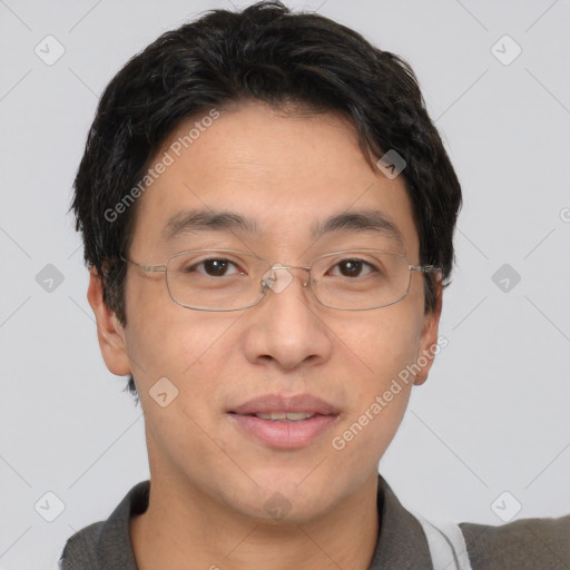 Joyful asian adult male with short  brown hair and brown eyes