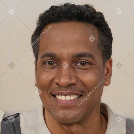 Joyful black adult male with short  black hair and brown eyes