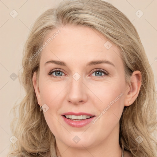 Joyful white young-adult female with long  brown hair and blue eyes