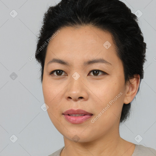 Joyful asian adult female with short  black hair and brown eyes