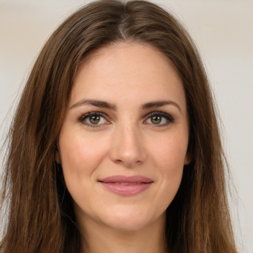 Joyful white young-adult female with long  brown hair and green eyes