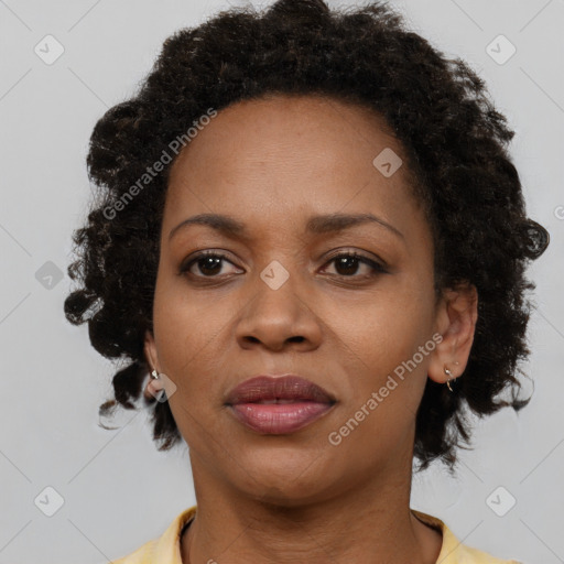 Joyful black adult female with short  brown hair and brown eyes