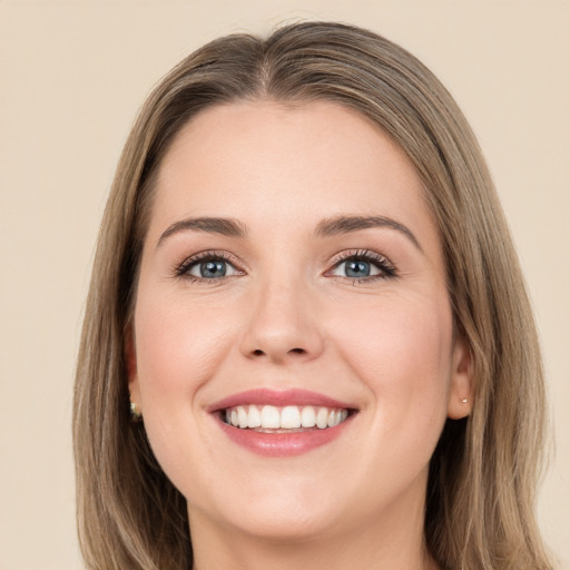 Joyful white young-adult female with long  brown hair and green eyes