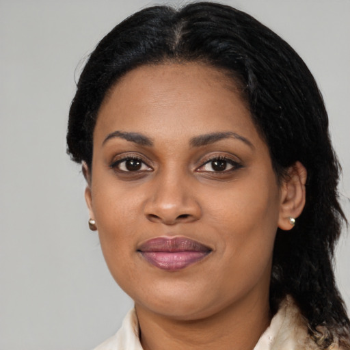 Joyful black adult female with medium  brown hair and brown eyes