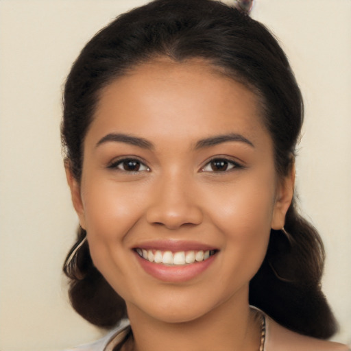 Joyful latino young-adult female with long  brown hair and brown eyes