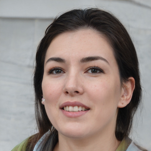 Joyful white young-adult female with medium  brown hair and brown eyes