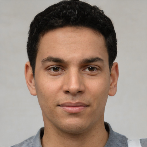 Joyful white young-adult male with short  black hair and brown eyes