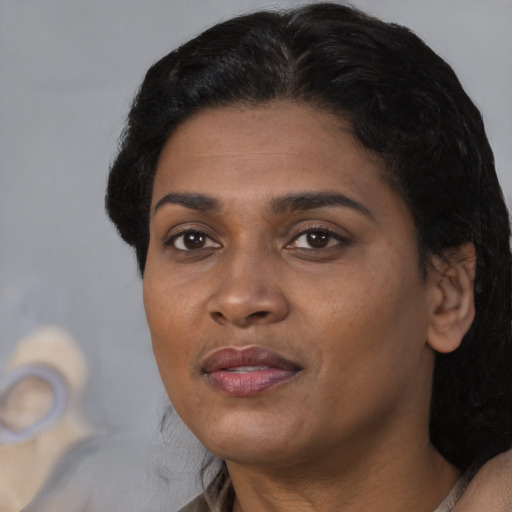 Joyful black adult female with medium  black hair and brown eyes