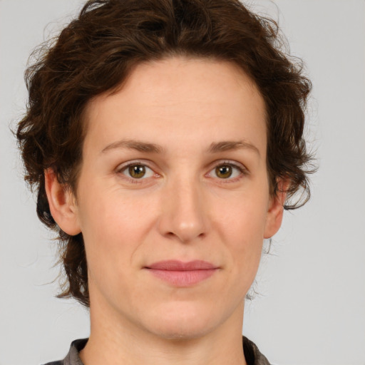 Joyful white young-adult female with medium  brown hair and green eyes