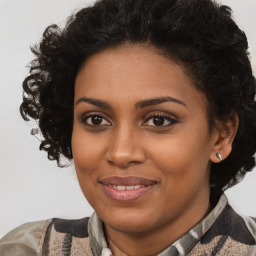 Joyful black young-adult female with short  brown hair and brown eyes