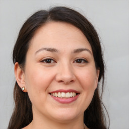 Joyful white young-adult female with medium  brown hair and brown eyes