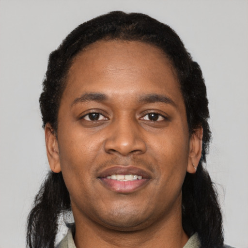 Joyful black young-adult male with short  black hair and brown eyes