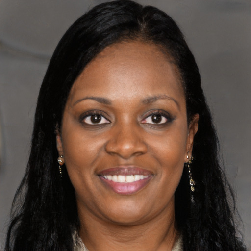 Joyful black young-adult female with long  brown hair and brown eyes