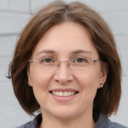 Joyful white adult female with medium  brown hair and grey eyes