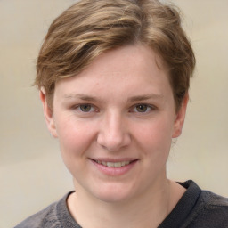 Joyful white young-adult female with short  brown hair and blue eyes