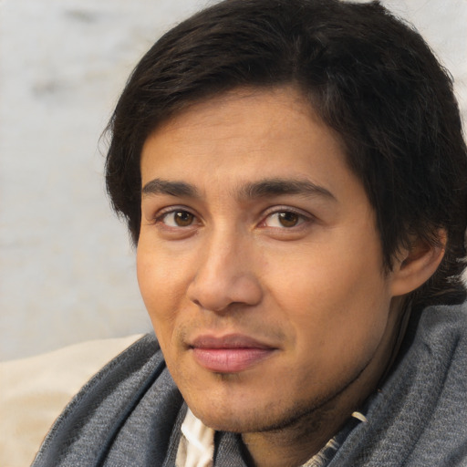 Joyful asian young-adult male with short  brown hair and brown eyes