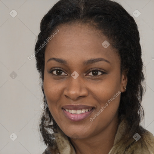 Joyful black young-adult female with long  brown hair and brown eyes