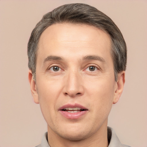 Joyful white adult male with short  brown hair and brown eyes