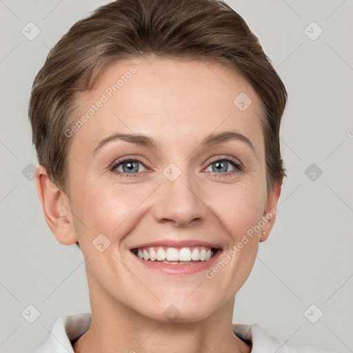 Joyful white adult female with short  brown hair and grey eyes