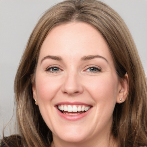 Joyful white young-adult female with long  brown hair and grey eyes