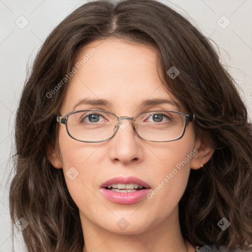 Joyful white adult female with long  brown hair and green eyes