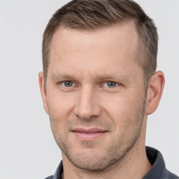 Joyful white adult male with short  brown hair and grey eyes