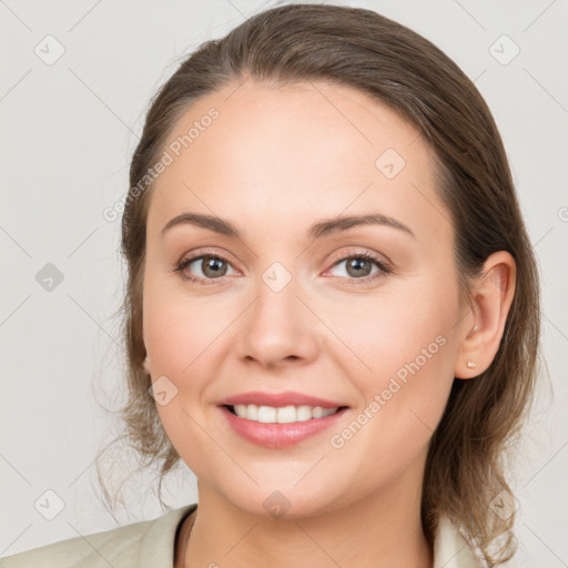 Joyful white young-adult female with medium  brown hair and grey eyes