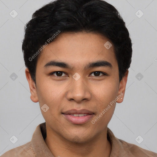 Joyful latino young-adult male with short  brown hair and brown eyes