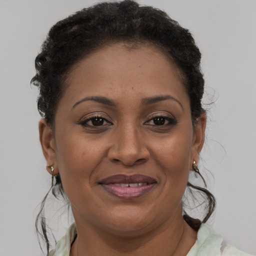 Joyful black adult female with short  brown hair and brown eyes