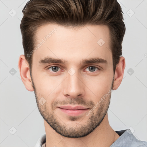 Joyful white young-adult male with short  brown hair and grey eyes