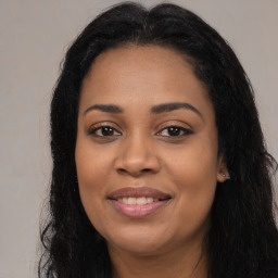 Joyful latino young-adult female with long  black hair and brown eyes