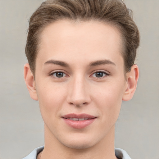 Joyful white young-adult female with short  brown hair and grey eyes