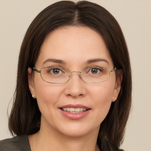 Joyful white adult female with medium  brown hair and green eyes