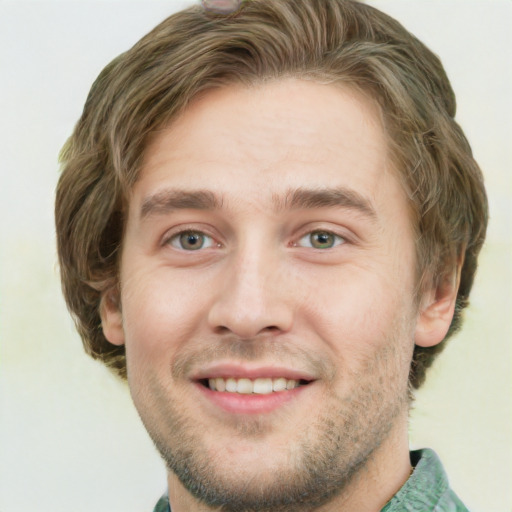 Joyful white young-adult male with short  brown hair and green eyes